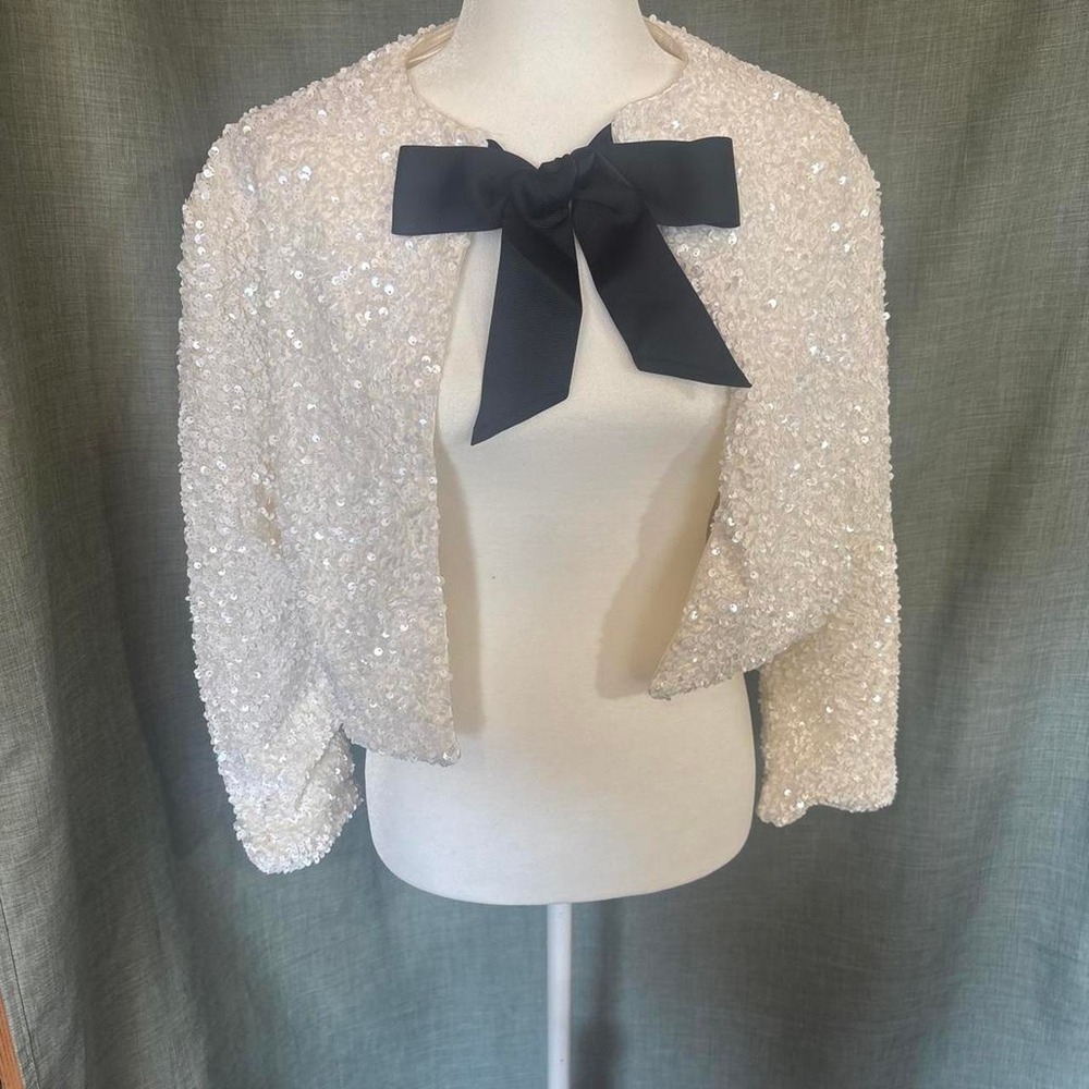 White sequin jacket with black tie